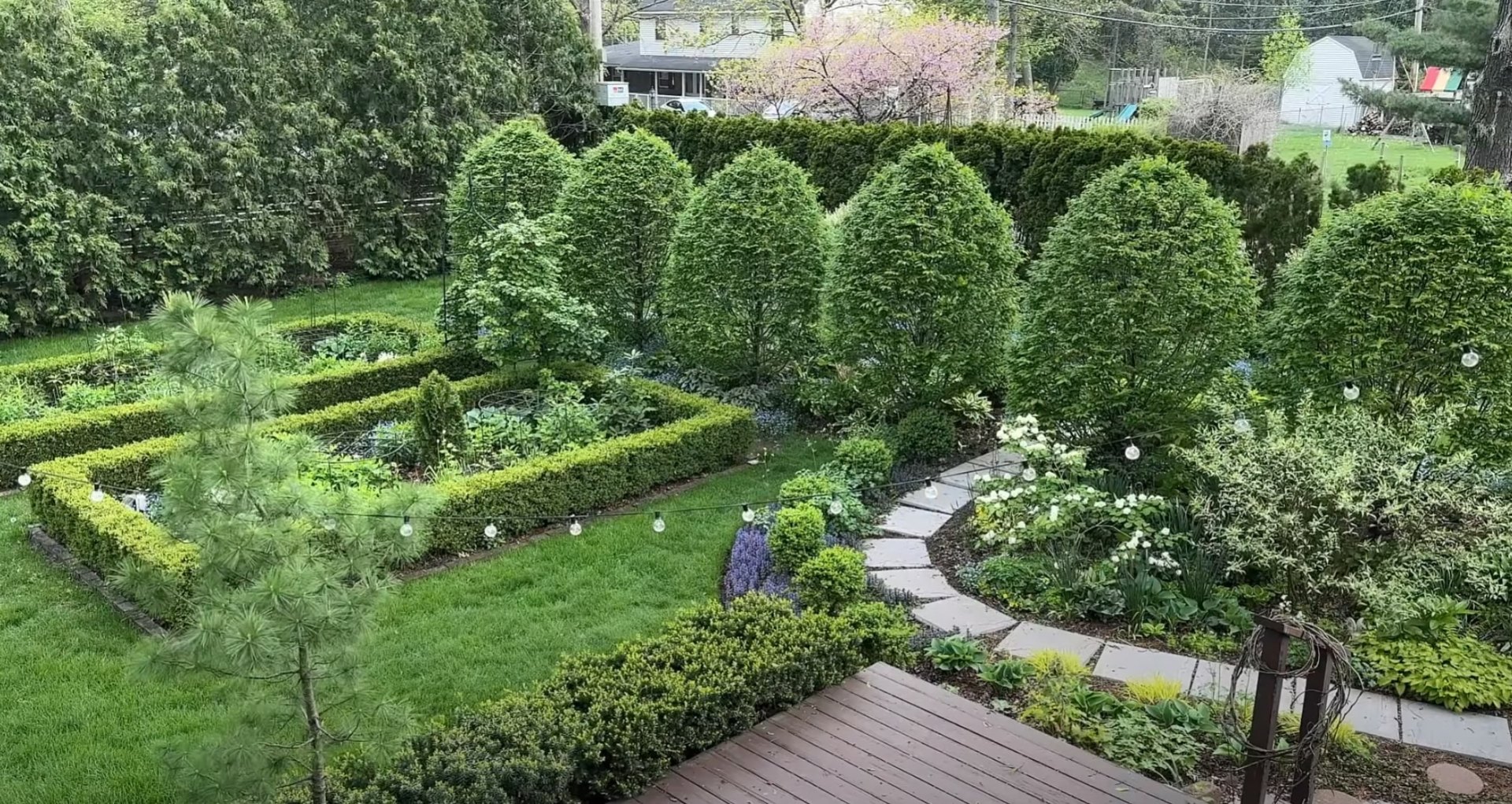 Aerial view of beautifully designed formal garden with geometric layout and mature trees
