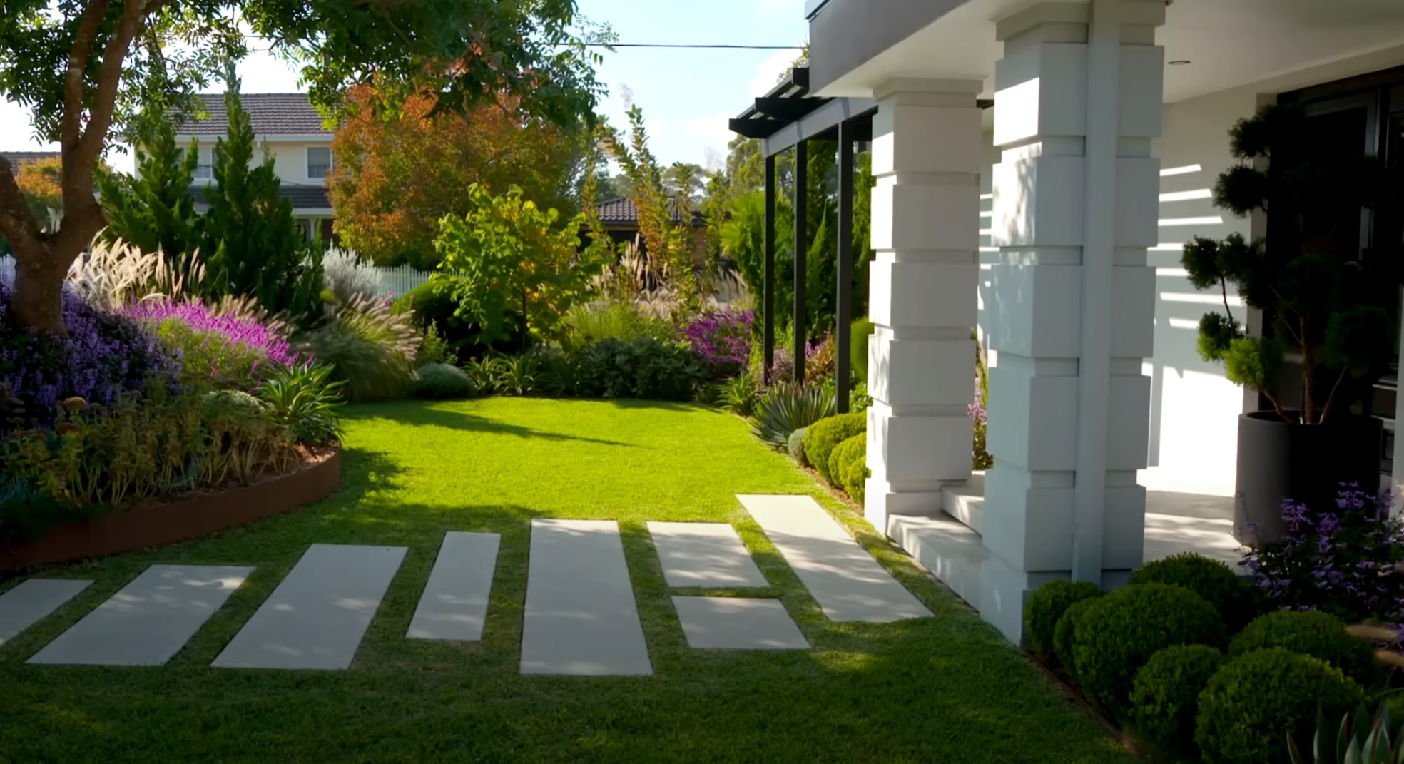 Elegant front yard design with modern stepping stones and colorful perennial plantings