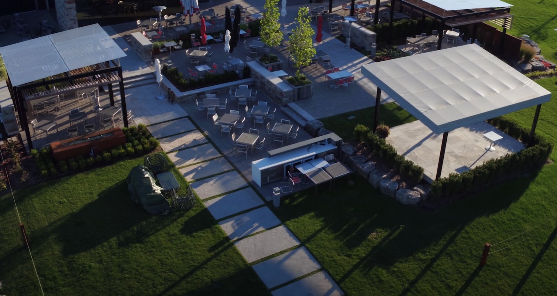 Aerial view of luxury outdoor entertainment area with modern fire pit and pool